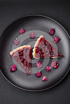 Delicious fragrant sweet pie with cherry berries on a ceramic plate