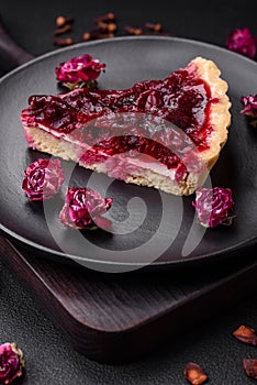 Delicious fragrant sweet pie with cherry berries on a ceramic plate