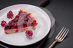 Delicious fragrant sweet pie with cherry berries on a ceramic plate