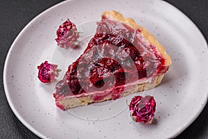 Delicious fragrant sweet pie with cherry berries on a ceramic plate