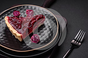 Delicious fragrant sweet pie with cherry berries on a ceramic plate