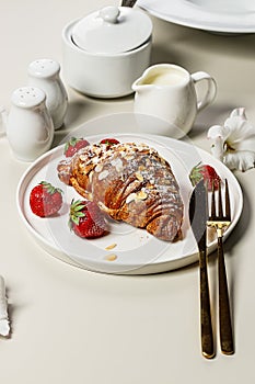 Delicious french breakfast. Crispy Croissants with fresh strawberries. Appetizing morning Sweet food. Light background