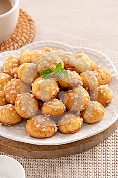 Delicious French Chouquette Choux Pastry dessert Pearl Sugar Puff on wooden table background