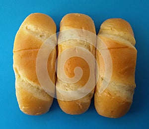 Delicious French roll breads. Soft and sweet buns over blue background.