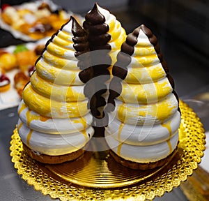 Delicious fresh baked colorful decorated pyramid cake pasteleria suiza on display in bakery in Bilbao, Basque Country, Spain photo