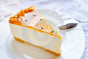 Delicious fresh baked multi-layered mango passionfruit cheesecake slice with fruit jelly glaze