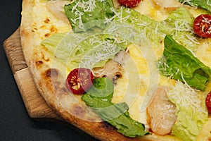 Delicious fresh cesar pizza with chicken and vegetables on wooden board