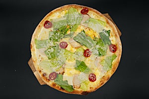 Delicious fresh cesar pizza with chicken and vegetables on wooden board