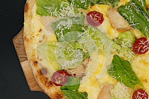 Delicious fresh cesar pizza with chicken and vegetables on wooden board