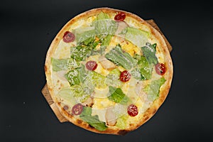 Delicious fresh cesar pizza with chicken and vegetables on wooden board