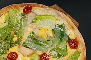 Delicious fresh cesar pizza with chicken and vegetables on wooden board