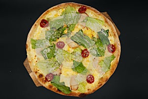 Delicious fresh cesar pizza with chicken and vegetables on wooden board