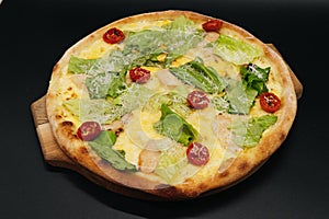 Delicious fresh cesar pizza with chicken and vegetables on wooden board