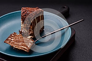 Delicious fresh cheesecake cake or snickers with cream and nuts on a ceramic plate