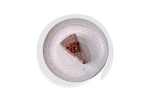 Delicious fresh cheesecake cake or snickers with cream and nuts on a ceramic plate