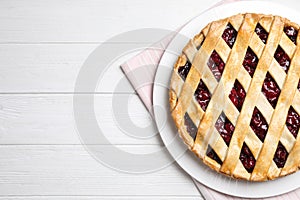 Delicious fresh cherry pie on white wooden table, flat lay. Space for text