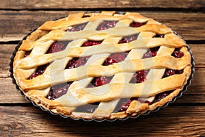 Delicious fresh cherry pie on wooden table