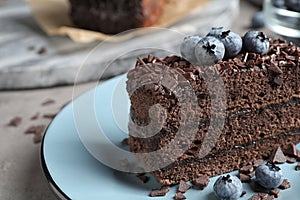 Delicious fresh chocolate cake with blueberries on table