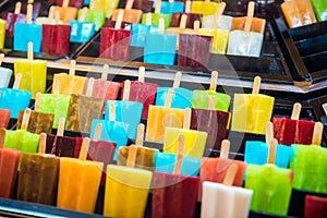 Delicious fresh colourful ice lolly on stick.