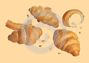 Delicious fresh croissants falling on beige background