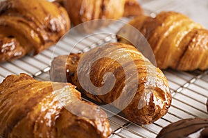 Delicious, fresh croissants on a grid, French breakfast