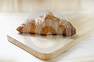 Delicious fresh croissants on wood background - French breakfast
