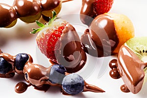 Delicious fresh fruit from a chocolate fondue photo