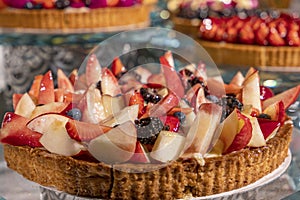 Delicious and fresh pies with sortiment  fruits like , banana, strawberry, ananas, peach, grape,