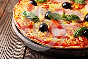 Delicious fresh pizza on brown wooden background