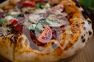 delicious fresh pizza with salami, basil and tomatoes
