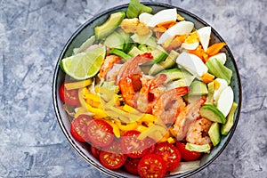 Delicious fresh salad with prawns, avocado, eggs, bell pepper, tomatoes