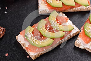 Delicious fresh sandwich with red fish, butter, bread and avocado