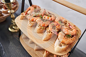 Delicious fresh seafood, shrimp with fresh vegetables. buffet table with lots of delicious snacks. canapes, bruschetta