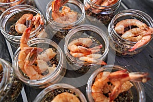Delicious fresh seafood, shrimp with fresh vegetables. buffet table with lots of delicious snacks. canapes, bruschetta