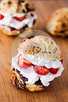 Delicious freshly baked scones filled with thick clotted cream photo