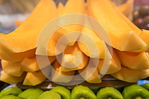 Delicious freshly cut kiwis and melons on sale on market