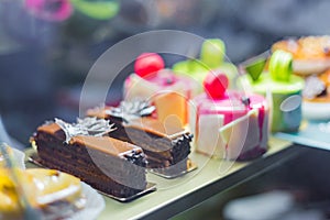 Delicious freshly layered cake pieces with cream and chocolate at bakery