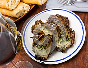 Delicious fried artichoke halves on a white plate