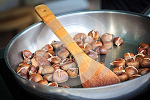 Delicious fried edible chestnuts castanea sativa lie in a frying pan