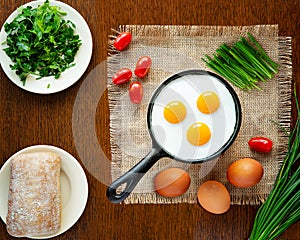 Delicious fried eggs in a hot pan
