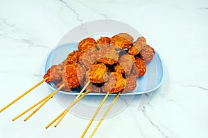 The delicious fried shrimp mixed with flour and seasonings on dish with marble background. Fried meatballs Made from meat. Asian