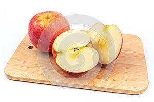 Delicious fruit Red ripe apples and cut apples on a cutting board on a white background.