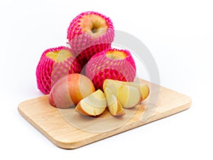 Delicious fruit Red ripe apples and sliced apples on a cutting board on a white background