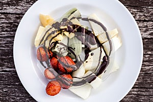 Delicious fruit salad with chocolate topping