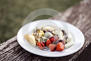 Delicious fruit salad with chocolate topping