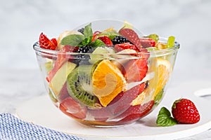 Delicious fruit salad on a plate on table