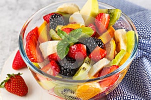 Delicious fruit salad on a plate on table