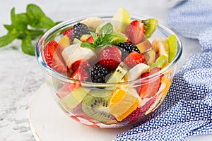 Delicious fruit salad on a plate on table