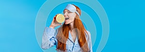 Delicious fruit starting morning healthy. Waist-up portrait attractive sleepy, pretty redhead girl in sleep mask and
