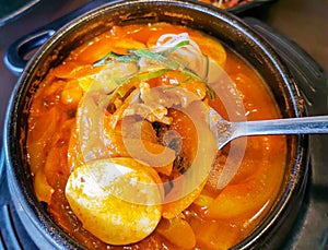 Delicious Gimchi Jjigae  or Kimchi Soup in a hot pot. photo